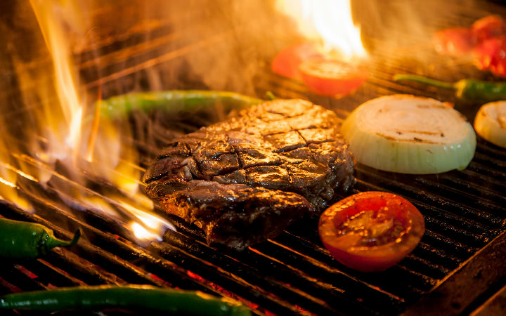 steak cooking on a BBQ