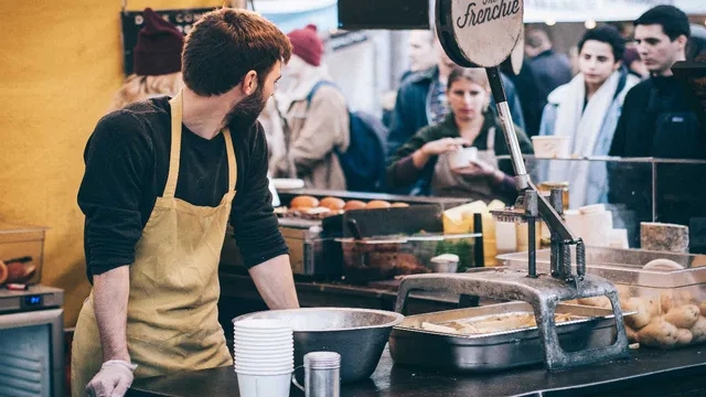 man cooking in an outdoor market