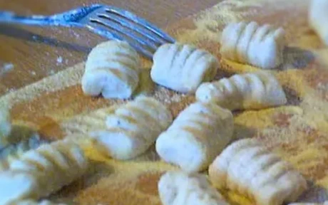 freshly rolled gnocchi on a wooden board