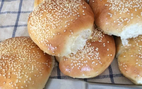 stack of sesame seed burger buns