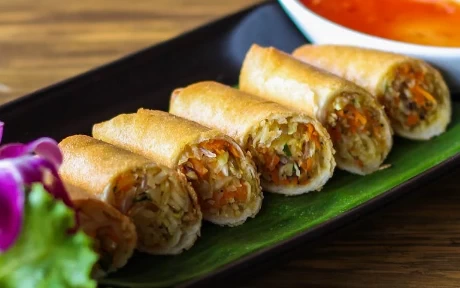 six spring rolls onn a plate