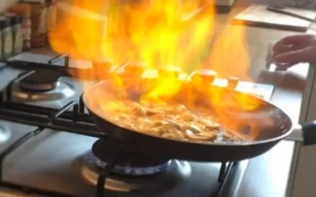beef stroganoff flambe in a pan