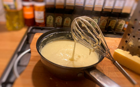 cheese sauce whisked in a pan