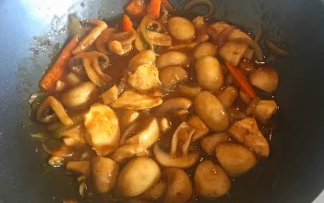 chicken and mushrooms in a wok