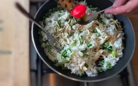 chicken fried rice cooking in a pan