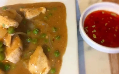 plate of chinese chicken curry and peas