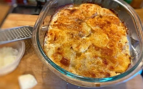 glass dish of potato gratin