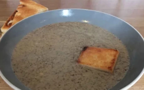 bowl of mushroom soup with a crouton