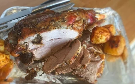 roast leg of lamb on a cooking tray