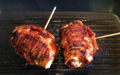 Rolled and stuffed chicken on a griddle pan