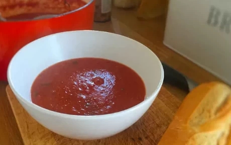 bowl of tomato soup with french loaf