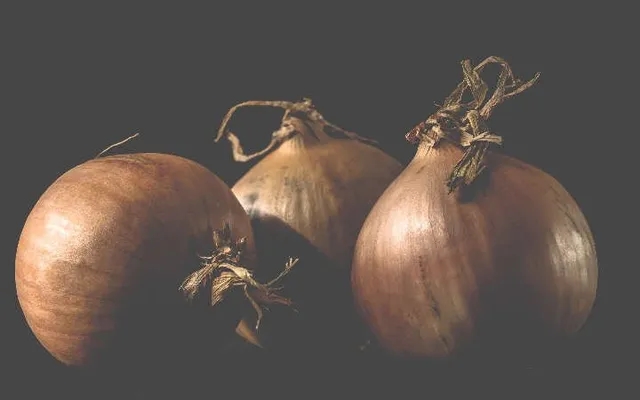 three loose brown onions